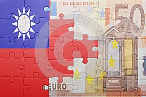 Puzzle with the national flag of taiwan and euro banknote