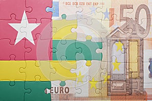 Puzzle with the national flag of togo and euro banknote