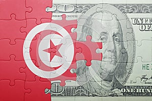 Puzzle with the national flag of tunisia and dollar banknote