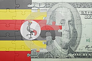 Puzzle with the national flag of uganda and dollar banknote