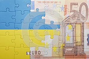 Puzzle with the national flag of ukraine and euro banknote