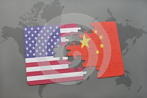 Puzzle with the national flag of united states of america and china on a world map background