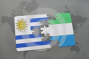 puzzle with the national flag of uruguay and sierra leone on a world map