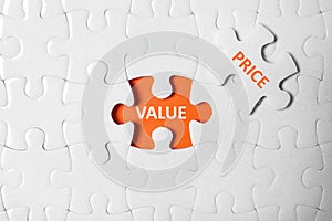 Puzzle with phrase PRICE VALUE on background, top view