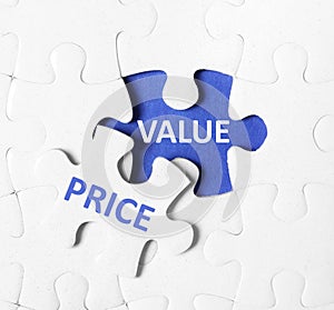 Puzzle with phrase PRICE VALUE on background, top view