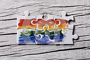 Puzzle pieces forming a rainbow flag
