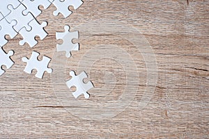 Puzzle pieces on wood table background. Business solutions, mission target, successful, goals, cooperation, partnership and