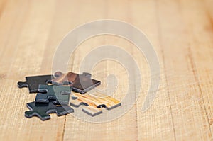 Puzzle pieces on a wooden background