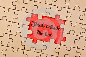 Puzzle pieces with word Think outside the box business concept image