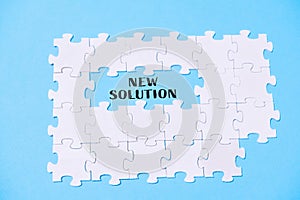 Puzzle with the word new solution written in the middle