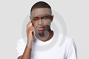 Puzzled African American man trying to remember important information