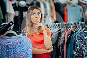Puzzled Entrepreneur Saleswoman Standing in her Own Clothing Shop