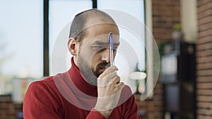 Puzzled male employee brainstorming ideas about business growth