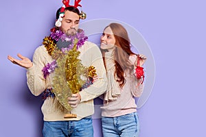 Puzzled man in Christmas tinsel