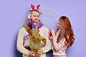 Puzzled man in Christmas tinsel