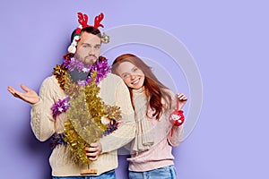 Puzzled man in Christmas tinsel