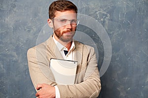 Puzzled man keeps lips pressed  on wall