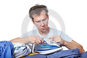 Puzzled man studying how to use an iron isolated white