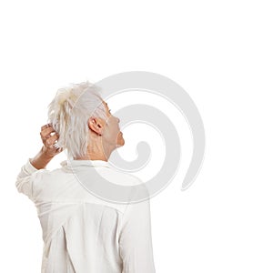 Puzzled older woman scratching her head photo