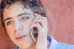 Puzzled teenager on phone
