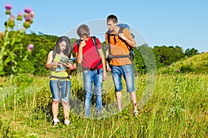 Puzzled teenagers looking into map photo