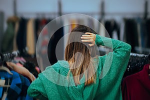 Puzzled Woman Thinking What to Buy in a Fashion Store