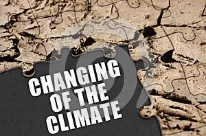 The puzzles depict soil, next to a black surface with the text - Changing of the climate