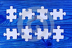 Puzzles on a wooden background in blue. business vision.