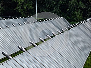 PV solar panels from solar field providing alternative green energy used for heating. Solar thermal collectors generating