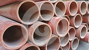 PVC ducts or pipes for power utilities in red colour piles nicely on top of each other.