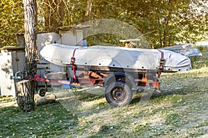 PVC inflatable boat under the tarp on the trailer