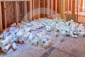 Pvc pipe fittings waiting for installation in new construction house.
