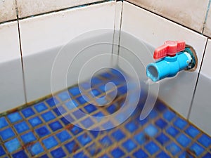 Pvc pipe with water faucet in tiled water bath