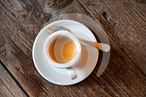 Pverhead shot of a cup of espresso coffee on a wooden restaurant table, Brussels city, Belgium