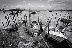 local wooden fishing boats in the shore photo