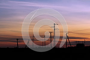 Pylon high voltage power line on sunset. Large towers of metal structures with electric wires on the sunset background.