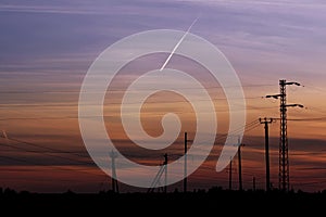 Pylon high voltage power line on sunset. Large towers of metal structures with electric wires on the sunset background.