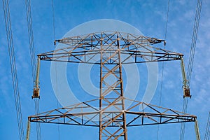 Pylon with insulatros and lines, wires. High voltage transmission line.