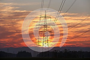 Pylon and power lines at sunrise