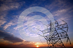 Pylon and power lines at sunset photo