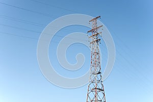 Pylon and transmission power line in front of sky.