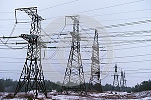 Pylon and transmission power line in summer day.