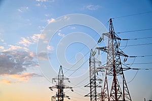 Pylon and transmission power line in sunset