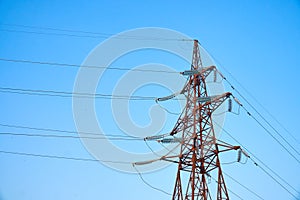 Pylon and transmission power line in sunset