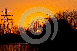 Pylons By Lake At Sunset