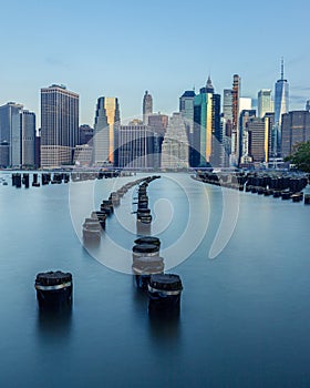 View of Lower Manhattan New York Skyline from Old Pier 1 in Brooklyn with Pylons in the East River