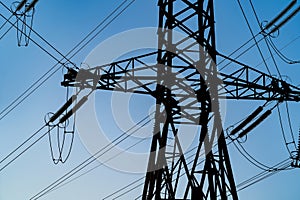 Pylons or transmission towers in countryside on beautiful blue sky background