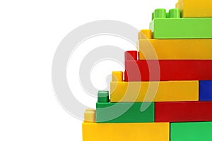 Pyramid assembled from the details of a multicolored bright constructor on a white isolated background