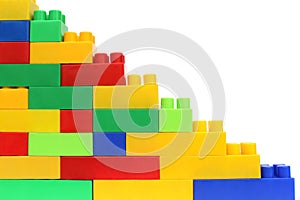 Pyramid assembled from the details of a multicolored bright constructor on a white isolated background