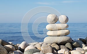 Pyramid of balanced stones on the background of the sea. Selective focus